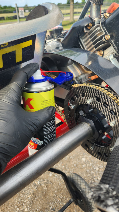 Person applying lube to a motorcycle engine